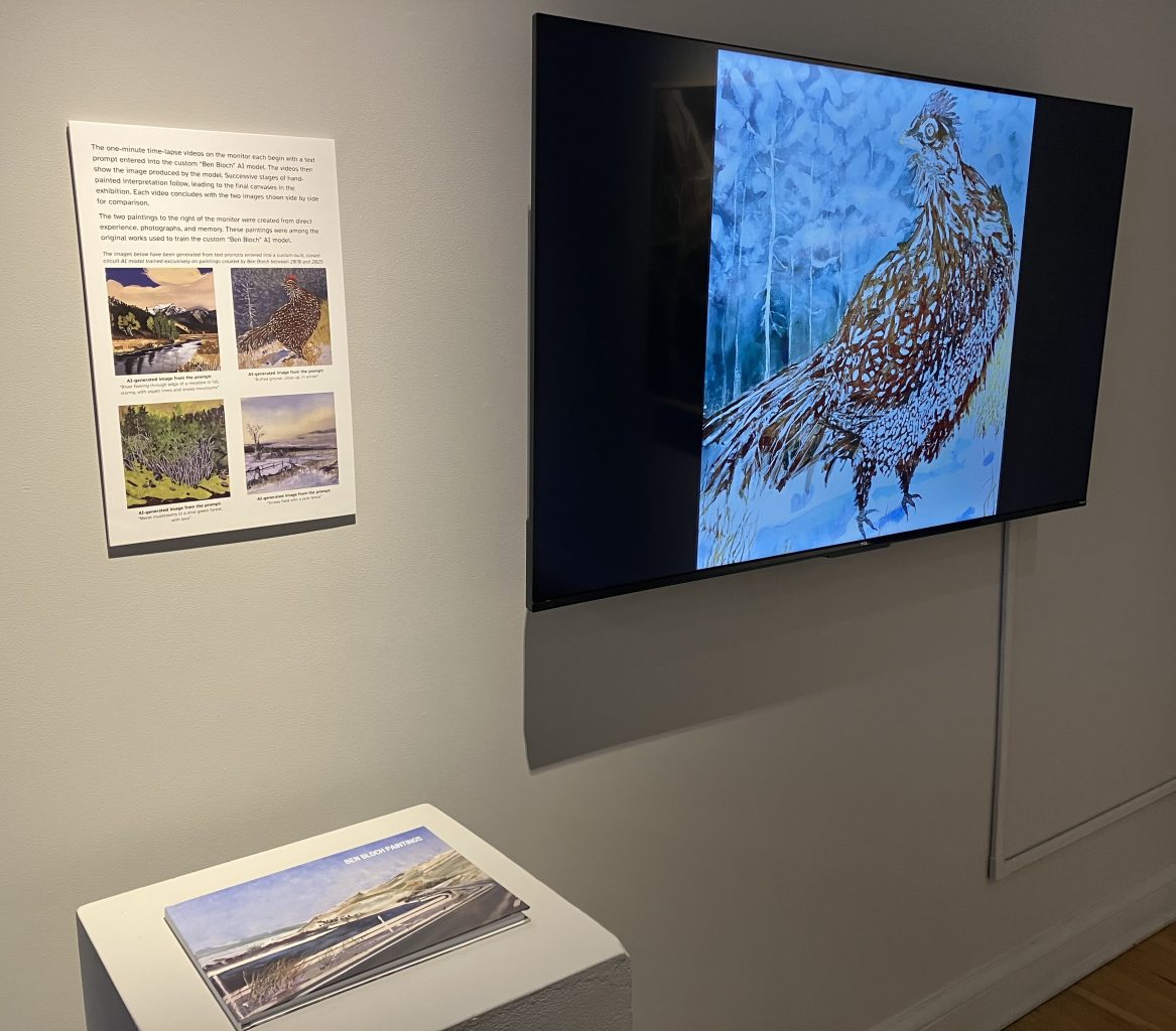 Gallery installation view showing a monitor displaying an AI-generated bird image, wall text explaining the process, and a pedestal with a book of Ben Bloch’s paintings.