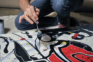 Jimmy Toro works on his painting for Art Meets Fashion