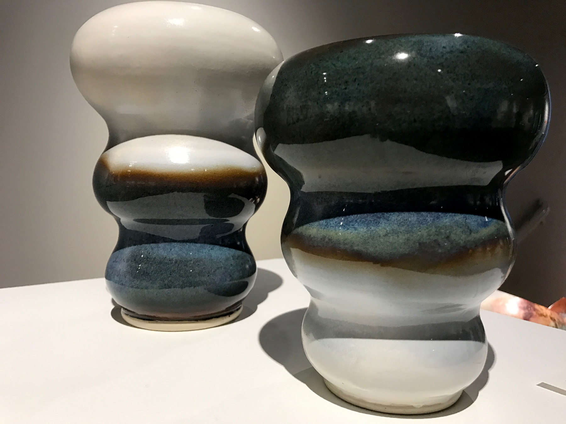 “Halo Vase II” (2017, 9 × 6 in) and “Halo Vase III” (2017, 7 × 5.5 in), high fired ceramic by Barbara Ellard