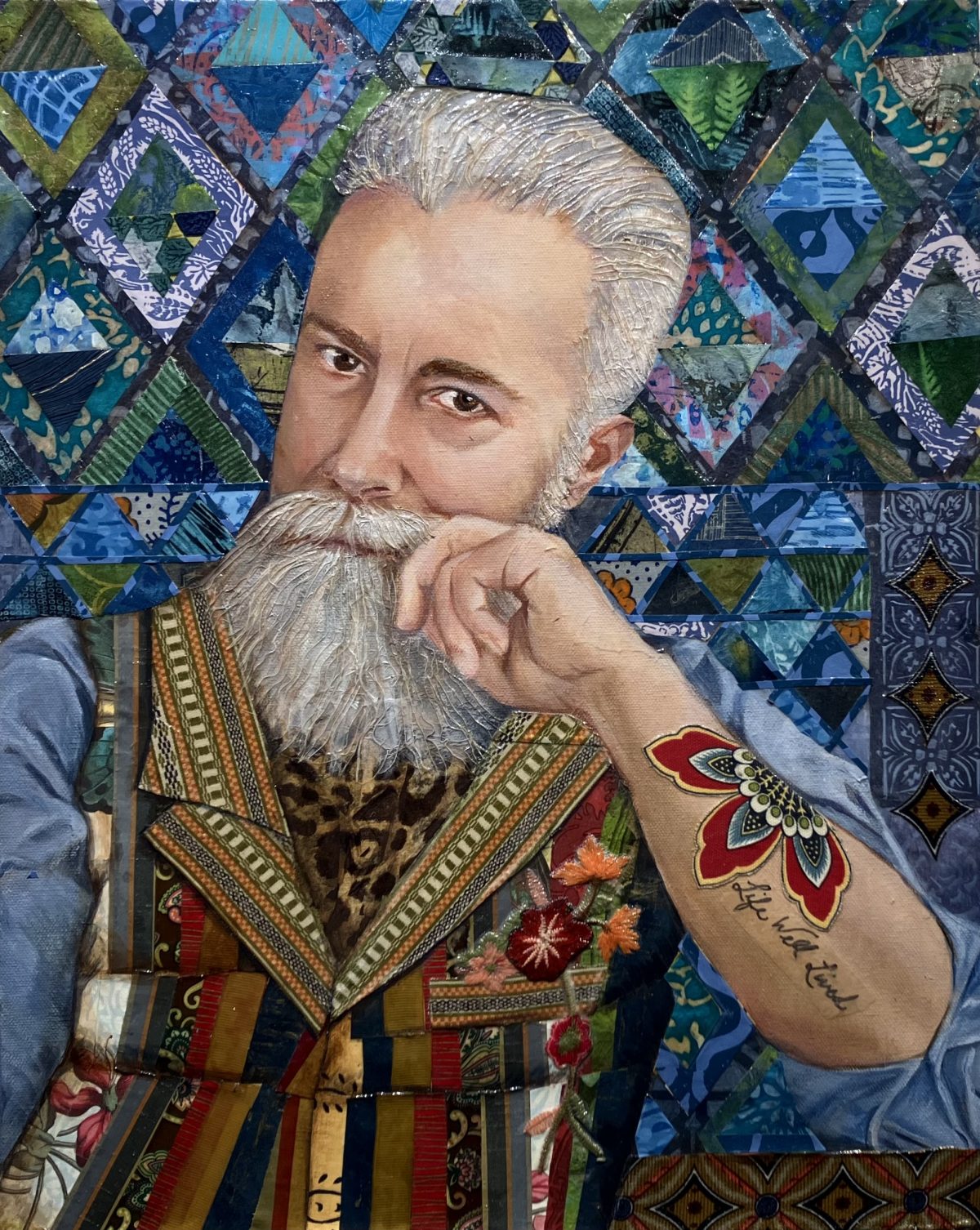 Portrait of a man with a contemplative expression, featuring a textured gray beard, colorful patchwork vest, and a tattoo on his forearm that reads 'Life Well Lived,' set against a vibrant geometric blue and green background.