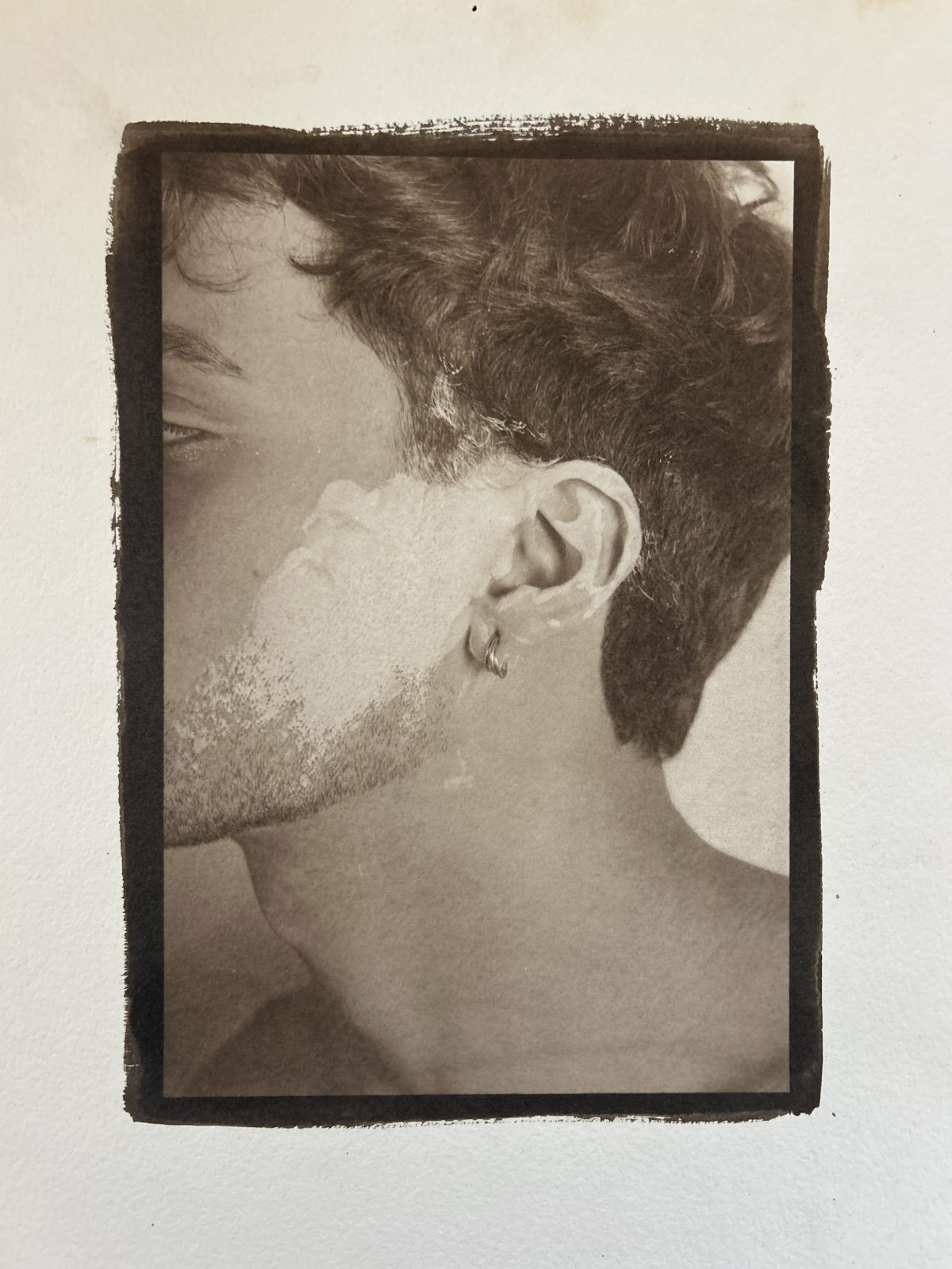 A sepia-toned Van Dyke brown print portrait of a young man in profile, featuring soft textures and a painterly quality.