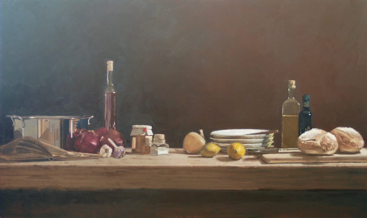 A still-life painting of a rustic kitchen scene with a wooden table set against a dark background. The table holds ingredients such as onions, garlic, lemons, bread, bottles of oil and vinegar, and a stainless steel pot, along with stacked plates and a cookbook.