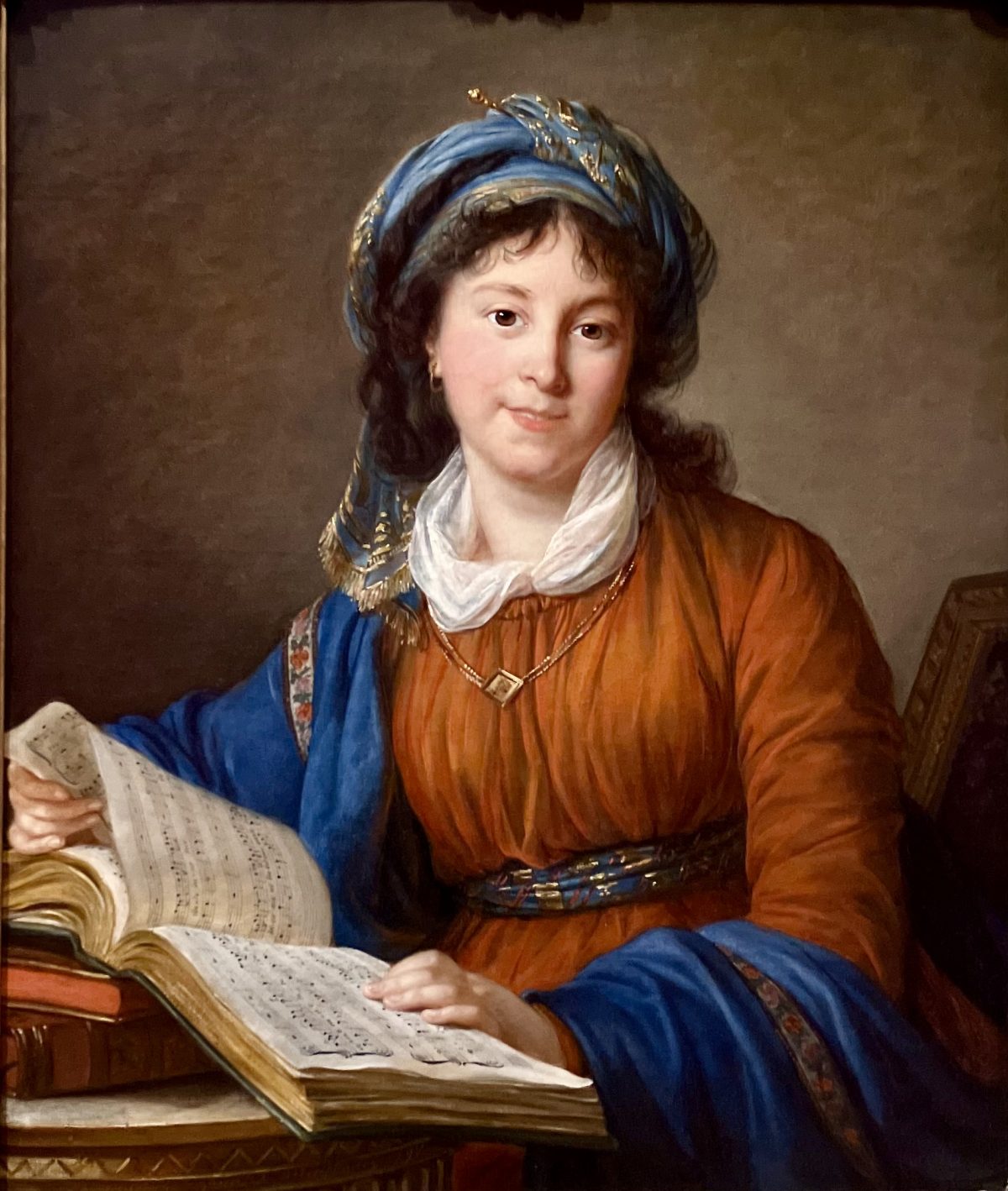 A classical portrait of a woman wearing a richly colored turban and gown, seated with a musical manuscript.