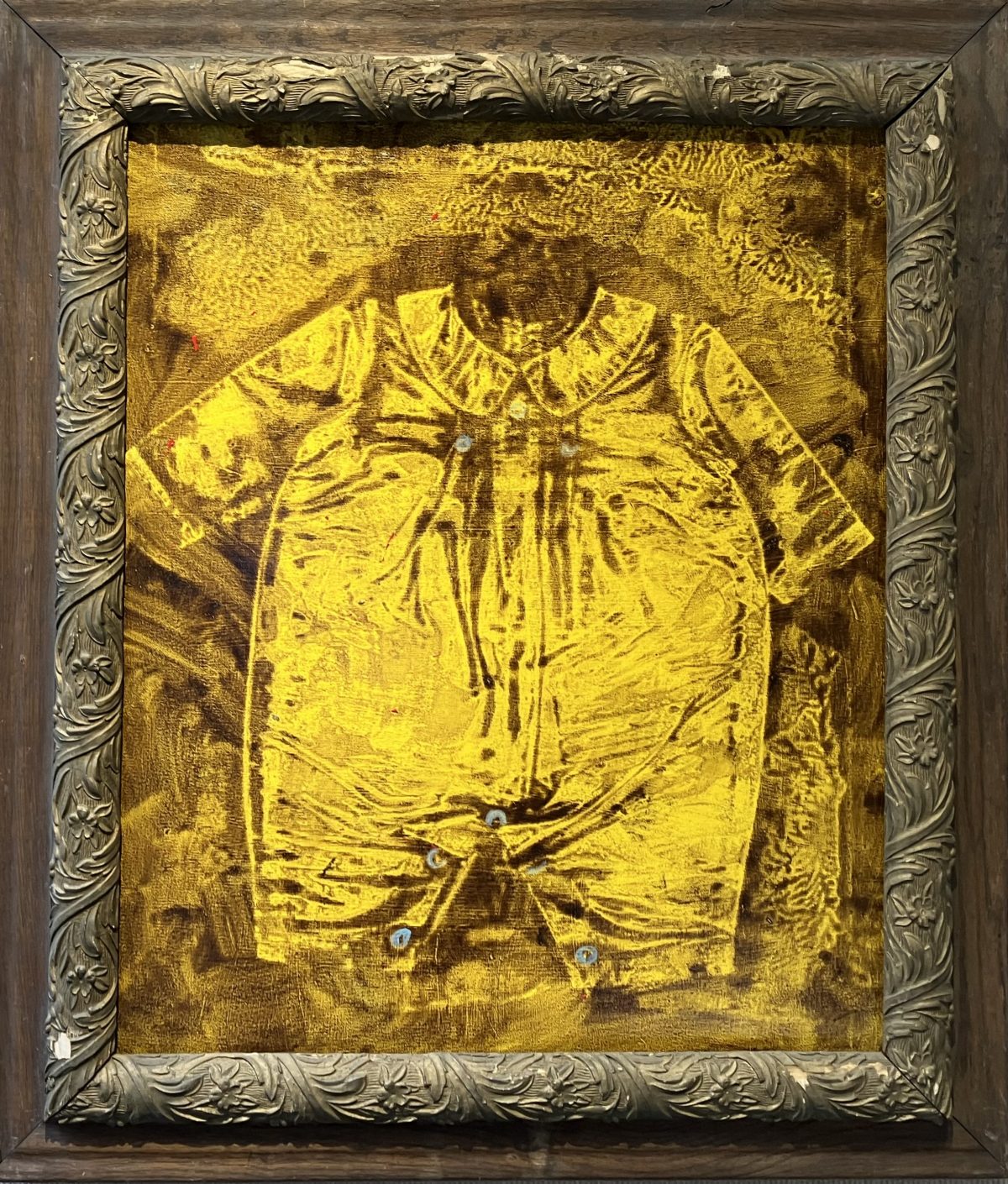 A golden-hued print of a vintage baby romper rendered in thick textured paint, framed with ornate wood detailing and set against a warm brown background.