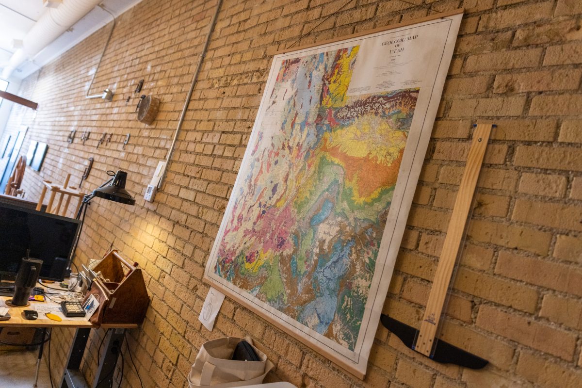 Large geologic map of Utah hanging on an exposed brick wall in the Books & Supply studio.