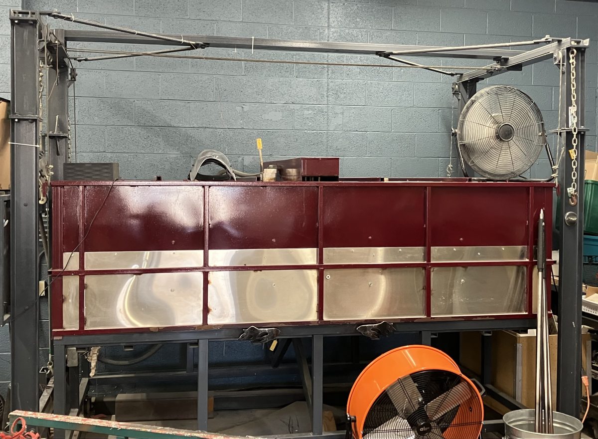 Large glass kiln with metal casing and surrounding ventilation fans inside Studio-de-Verre.